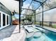 Screened pool and patio with plenty of seating and a built-in grill at 13333 Early Frost Cir, Orlando, FL 32828