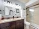 Elegant bathroom with double vanity, granite countertop, and walk-in shower at 13333 Early Frost Cir, Orlando, FL 32828