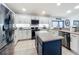Updated kitchen featuring stainless steel appliances, white shaker cabinets, and a spacious island at 13333 Early Frost Cir, Orlando, FL 32828