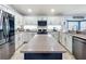Renovated kitchen with granite countertops, stainless steel appliances, and a center island at 13333 Early Frost Cir, Orlando, FL 32828