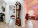 Hallway with grandfather clock and views into bedrooms at 13333 Early Frost Cir, Orlando, FL 32828