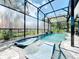 Relaxing pool area with screened enclosure and comfortable lounge chairs at 13333 Early Frost Cir, Orlando, FL 32828