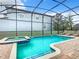 Inviting screened pool and spa with lounge chairs at 1458 Rolling Fairway Dr, Davenport, FL 33896