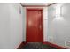 Building entry with red door and neutral colored walls at 231 Riverside Drive # 1209-1, Holly Hill, FL 32117