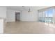 Bright living room with tile floors and access to a balcony with water views at 231 Riverside Drive # 1209-1, Holly Hill, FL 32117