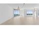 Bright living room with tile floors, large windows, and chandelier at 231 Riverside Drive # 1209-1, Holly Hill, FL 32117