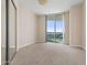 Bedroom with carpet flooring and sliding glass doors to balcony at 231 Riverside Drive # 1209-1, Holly Hill, FL 32117