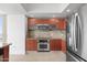 Modern kitchen with stainless steel appliances and wood cabinets at 231 Riverside Drive # 1209-1, Holly Hill, FL 32117