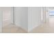 Neutral colored hallway with tiled floors and baseboards at 231 Riverside Drive # 1209-1, Holly Hill, FL 32117