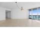 Spacious living area with access to a balcony and water views at 231 Riverside Drive # 1209-1, Holly Hill, FL 32117
