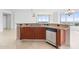 Kitchen island with granite countertop and stainless steel dishwasher at 231 Riverside Drive # 1209-1, Holly Hill, FL 32117