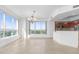 Spacious dining area with large windows and a modern chandelier at 231 Riverside Drive # 1209-1, Holly Hill, FL 32117