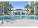 Community pool with building and palm trees in background at 231 Riverside Drive # 1209-1, Holly Hill, FL 32117