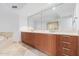 Bathroom features a double vanity with wood cabinets and large mirror at 231 Riverside Drive # 1209-1, Holly Hill, FL 32117