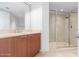 Bathroom with wood vanity, tiled shower, and mirror at 231 Riverside Drive # 1209-1, Holly Hill, FL 32117