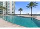 Relaxing pool with water access and building view at 231 Riverside Drive # 1209-1, Holly Hill, FL 32117