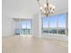 Spacious living room with tile floors, large windows and chandelier at 231 Riverside Drive # 1209-1, Holly Hill, FL 32117