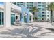 Relaxing patio furniture with palm trees and building view at 231 Riverside Drive # 1209-1, Holly Hill, FL 32117