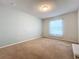 Spacious bedroom with carpeted floor, window with curtains, and neutral wall colors at 8829 Corcovado Dr, Kissimmee, FL 34747