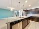 Modern kitchen with island, granite countertops, stainless steel appliances, and pendant lighting at 8829 Corcovado Dr, Kissimmee, FL 34747