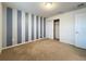 Bedroom with grey and white striped wall and carpet flooring at 8829 Corcovado Dr, Kissimmee, FL 34747