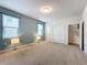 Bright bedroom with neutral walls and carpet, access to hallway at 8829 Corcovado Dr, Kissimmee, FL 34747