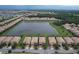 Aerial view of houses surrounding a lake at 8829 Corcovado Dr, Kissimmee, FL 34747