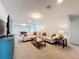 Spacious Gathering room with neutral carpeting and comfortable seating at 8829 Corcovado Dr, Kissimmee, FL 34747