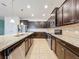 Modern kitchen with island, granite countertops, and stainless steel appliances at 8829 Corcovado Dr, Kissimmee, FL 34747