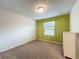 Bedroom with green accent wall and carpet at 8829 Corcovado Dr, Kissimmee, FL 34747