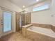 Bathroom with soaking tub, walk-in shower, and private access at 8829 Corcovado Dr, Kissimmee, FL 34747