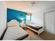 Bedroom with two twin beds and blue wall at 8829 Corcovado Dr, Kissimmee, FL 34747
