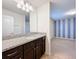 Bathroom with dark brown vanity, granite countertop, and view to bedroom at 8829 Corcovado Dr, Kissimmee, FL 34747