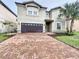 Two-story house with a brown brick driveway at 8829 Corcovado Dr, Kissimmee, FL 34747