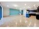 Open concept living room and kitchen with tile floors and an accent wall at 8829 Corcovado Dr, Kissimmee, FL 34747