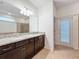 Double vanity bathroom with granite countertop and walk-in shower at 8829 Corcovado Dr, Kissimmee, FL 34747