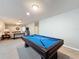 Game room with pool table and adjacent sitting area at 8829 Corcovado Dr, Kissimmee, FL 34747