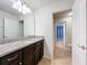 Bathroom boasts dark brown vanity with granite countertop at 8829 Corcovado Dr, Kissimmee, FL 34747