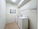 Bright laundry room, washer, dryer, and ample shelving at 8829 Corcovado Dr, Kissimmee, FL 34747