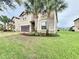 Two-story house with landscaped yard at 8829 Corcovado Dr, Kissimmee, FL 34747