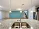 Kitchen island with granite countertop and double sink at 8829 Corcovado Dr, Kissimmee, FL 34747