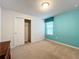 Bedroom with teal accent wall and carpet at 8829 Corcovado Dr, Kissimmee, FL 34747