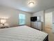 King-size bed, TV, dresser, and closet at 8829 Corcovado Dr, Kissimmee, FL 34747