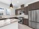 Modern kitchen with island, stainless steel appliances and dark cabinetry at 2122 Whitney Marsh Aly, Orlando, FL 32804