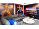 Gathering room with Marvel character wall art and a large TV at 2965 Protagonist St, Kissimmee, FL 34746