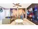 Gathering room with Marvel Superheroes wall art and a large TV at 2965 Protagonist St, Kissimmee, FL 34746
