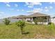Spacious backyard, grassy area, and screened patio at 5716 Lakeside Landings Blvd, Winter Haven, FL 33881