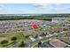 Aerial view showcasing a house's location within a residential community at 5716 Lakeside Landings Blvd, Winter Haven, FL 33881