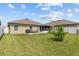 Large backyard with grassy lawn and patio at 5716 Lakeside Landings Blvd, Winter Haven, FL 33881