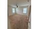 Well-lit bedroom featuring neutral carpeting and ceiling fan at 5716 Lakeside Landings Blvd, Winter Haven, FL 33881